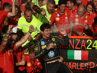 Charles Leclerc of Ferrari celebrates with the team after the Formula 1 Italian Grand Prix at Autodromo Nazionale di Monza in Monza, Italy o...