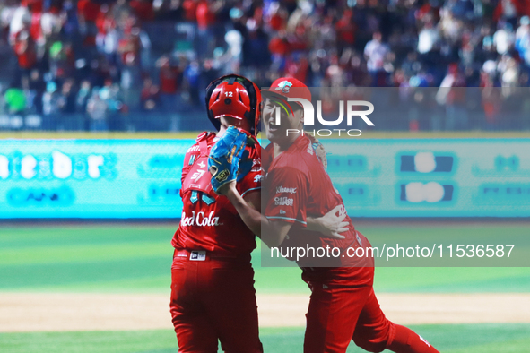 Patrick Mazeika #12 and Tomohiro Anraku #20 of Diablos Rojos celebrate after match 6 of the Mexican Baseball League (LMB) South Zone 2024 ch...