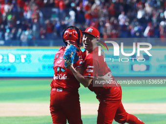 Patrick Mazeika #12 and Tomohiro Anraku #20 of Diablos Rojos celebrate after match 6 of the Mexican Baseball League (LMB) South Zone 2024 ch...