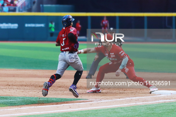 Jose Marmolejos #46 of Diablos Rojos tags Jorge Flores #3 of Guerreros de Oaxaca during match 6 of the Mexican Baseball League (LMB) South Z...