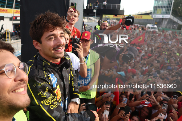 Charles Leclerc of Ferrari ceelbrates with fans after the Formula 1 Italian Grand Prix at Autodromo Nazionale di Monza in Monza, Italy on Se...