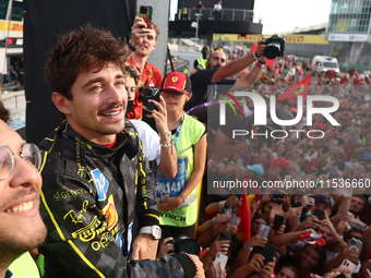 Charles Leclerc of Ferrari ceelbrates with fans after the Formula 1 Italian Grand Prix at Autodromo Nazionale di Monza in Monza, Italy on Se...