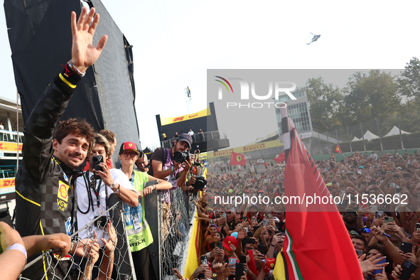 Charles Leclerc of Ferrari ceelbrates with fans after the Formula 1 Italian Grand Prix at Autodromo Nazionale di Monza in Monza, Italy on Se...