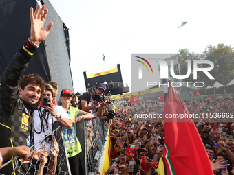 Charles Leclerc of Ferrari ceelbrates with fans after the Formula 1 Italian Grand Prix at Autodromo Nazionale di Monza in Monza, Italy on Se...