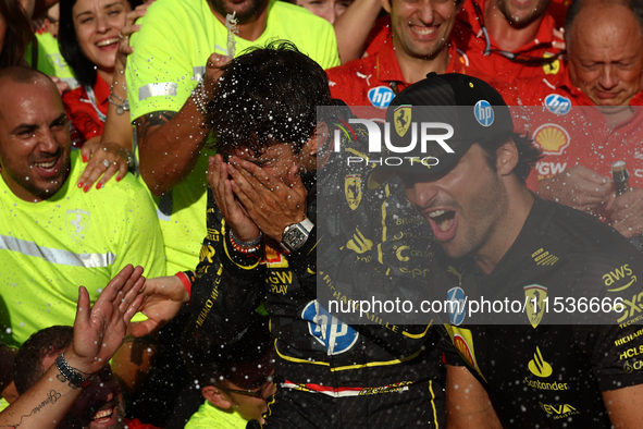 Charles Leclerc and Carlos Sainz of Ferrari celebrate with the team after the Formula 1 Italian Grand Prix at Autodromo Nazionale di Monza i...