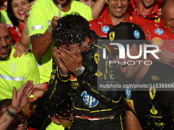 Charles Leclerc and Carlos Sainz of Ferrari celebrate with the team after the Formula 1 Italian Grand Prix at Autodromo Nazionale di Monza i...