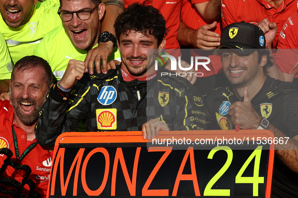 Charles Leclerc and Carlos Sainz of Ferrari celebrate with the team after the Formula 1 Italian Grand Prix at Autodromo Nazionale di Monza i...