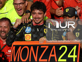 Charles Leclerc and Carlos Sainz of Ferrari celebrate with the team after the Formula 1 Italian Grand Prix at Autodromo Nazionale di Monza i...