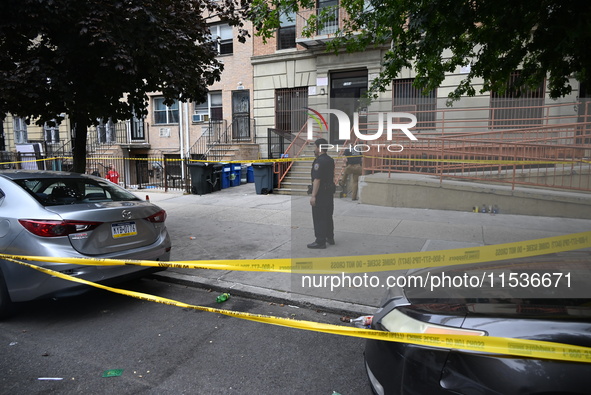 A police officer guards the crime scene. A 37-year-old male is shot and killed in Brooklyn, New York, United States, on September 1, 2024. A...