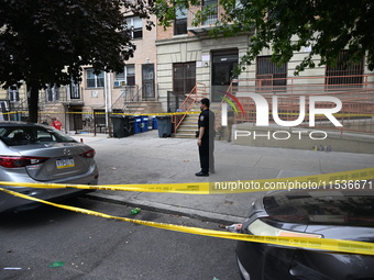 A police officer guards the crime scene. A 37-year-old male is shot and killed in Brooklyn, New York, United States, on September 1, 2024. A...