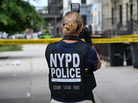 A New York City Police Department crime scene unit officer collects evidence at the scene. A 37-year-old male is shot and killed in Brooklyn...