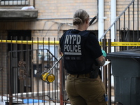 A New York City Police Department crime scene unit officer is at the scene. A 37-year-old male is shot and killed in Brooklyn, New York, Uni...