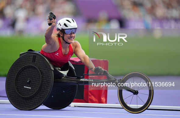 Catherine Debrunner of Switzerland celebrates winning gold in Women's 800m - T53 Final during the Paris 2024 Paralympic Games at Stade de Fr...