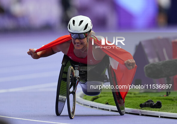 Catherine Debrunner of Switzerland celebrates winning gold in Women's 800m - T53 Final during the Paris 2024 Paralympic Games at Stade de Fr...