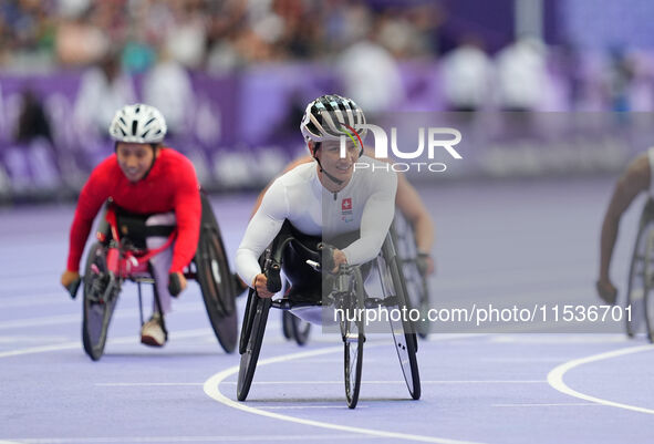 Manuela Schaer of Switzerland celebrates winning gold in Women's 800m - T54 Final during the Paris 2024 Paralympic Games at Stade de France...