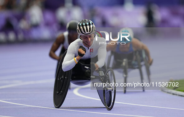 Manuela Schaer of Switzerland celebrates winning gold in Women's 800m - T54 Final during the Paris 2024 Paralympic Games at Stade de France...