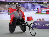 Manuela Schaer of Switzerland celebrates winning gold in Women's 800m - T54 Final during the Paris 2024 Paralympic Games at Stade de France...