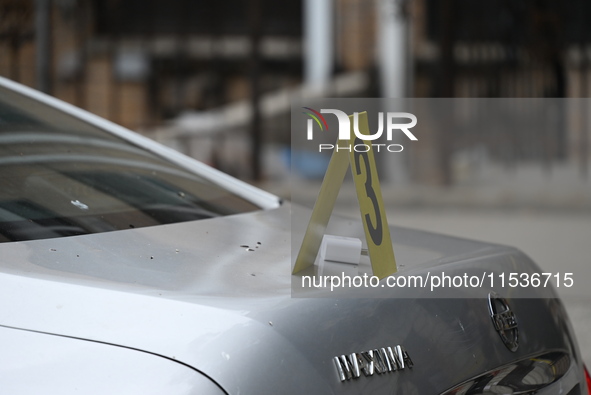 An evidence marker marks where a phone charger is found at the crime scene. A 37-year-old male is shot and killed in Brooklyn, New York, Uni...