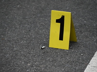 An evidence marker marks where a shell casing is found at the crime scene. A 37-year-old male is shot and killed in Brooklyn, New York, Unit...