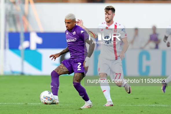 Dodo of ACF Fiorentina and Georgios Kyriakopoulos of AC Monza compete for the ball during the Serie A Enilive match between ACF Fiorentina a...