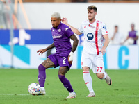 Dodo of ACF Fiorentina and Georgios Kyriakopoulos of AC Monza compete for the ball during the Serie A Enilive match between ACF Fiorentina a...