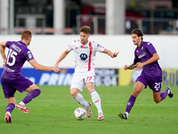 Georgios Kyriakopoulos of AC Monza is challenged by Pietro Comuzzo of ACF Fiorentina during the Serie A Enilive match between ACF Fiorentina...