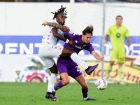 Warren Bondo of AC Monza and Andrea Colpani of ACF Fiorentina compete for the ball during the Serie A Enilive match between ACF Fiorentina a...