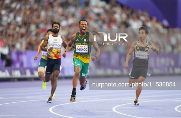 Mpumelelo Mhlongo of South Africa celebrates winning gold in Men's 100m - T44 Final during the Paris 2024 Paralympic Games at Stade de Franc...