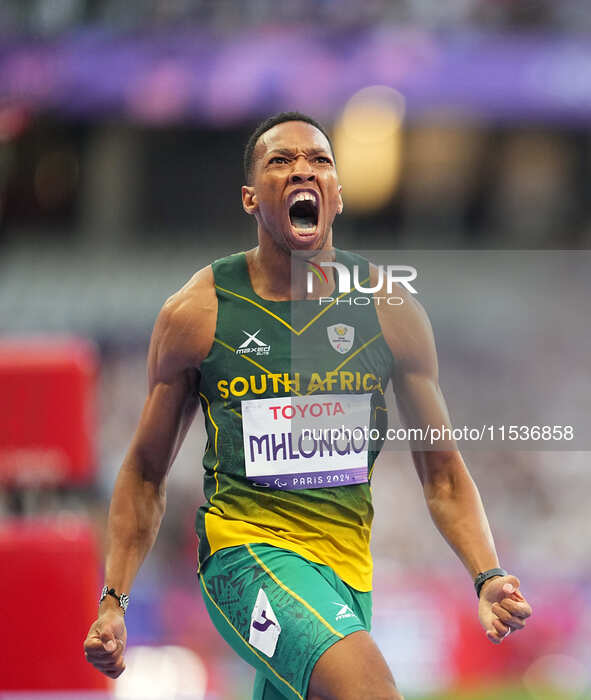 Mpumelelo Mhlongo of South Africa celebrates winning gold in Men's 100m - T44 Final during the Paris 2024 Paralympic Games at Stade de Franc...