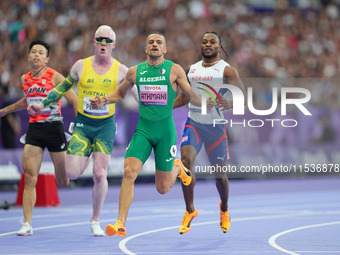 Djamil Skander Athmani of Algeria celebrates winning gold in Men's 100m - T13 Final during the Paris 2024 Paralympic Games at Stade de Franc...