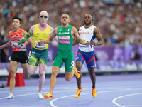 Djamil Skander Athmani of Algeria celebrates winning gold in Men's 100m - T13 Final during the Paris 2024 Paralympic Games at Stade de Franc...