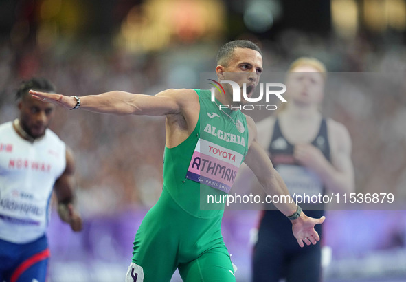 Djamil Skander Athmani of Algeria celebrates winning gold in Men's 100m - T13 Final during the Paris 2024 Paralympic Games at Stade de Franc...