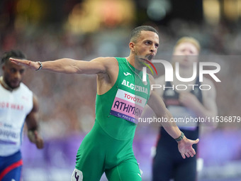 Djamil Skander Athmani of Algeria celebrates winning gold in Men's 100m - T13 Final during the Paris 2024 Paralympic Games at Stade de Franc...