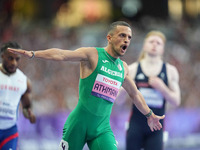 Djamil Skander Athmani of Algeria celebrates winning gold in Men's 100m - T13 Final during the Paris 2024 Paralympic Games at Stade de Franc...