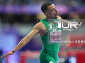 Djamil Skander Athmani of Algeria celebrates winning gold in Men's 100m - T13 Final during the Paris 2024 Paralympic Games at Stade de Franc...