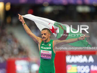 Djamil Skander Athmani of Algeria celebrates winning gold in Men's 100m - T13 Final during the Paris 2024 Paralympic Games at Stade de Franc...