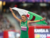 Djamil Skander Athmani of Algeria celebrates winning gold in Men's 100m - T13 Final during the Paris 2024 Paralympic Games at Stade de Franc...