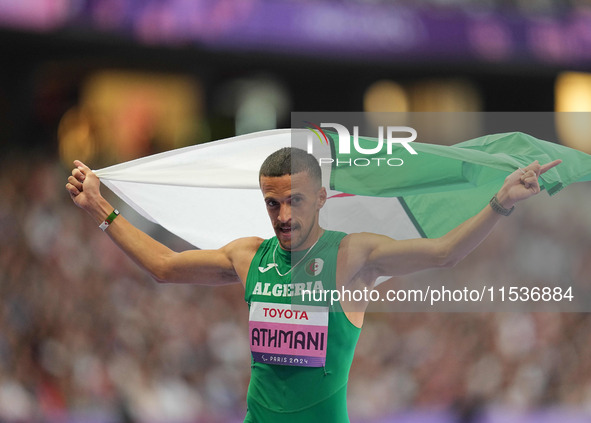 Djamil Skander Athmani of Algeria celebrates winning gold in Men's 100m - T13 Final during the Paris 2024 Paralympic Games at Stade de Franc...