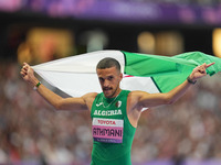 Djamil Skander Athmani of Algeria celebrates winning gold in Men's 100m - T13 Final during the Paris 2024 Paralympic Games at Stade de Franc...