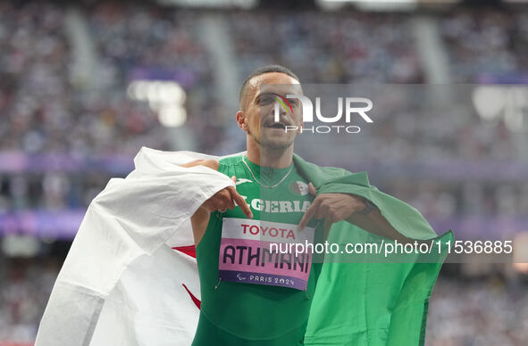 Djamil Skander Athmani of Algeria celebrates winning gold in Men's 100m - T13 Final during the Paris 2024 Paralympic Games at Stade de Franc...