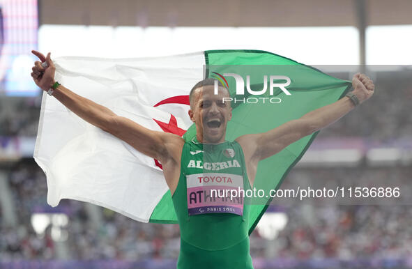 Djamil Skander Athmani of Algeria celebrates winning gold in Men's 100m - T13 Final during the Paris 2024 Paralympic Games at Stade de Franc...