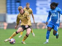 Andy Cannon (8 Wrexham) is challenged by Abraham Odoh (10 Peterborough United) during the Sky Bet League 1 match between Peterborough and Wr...