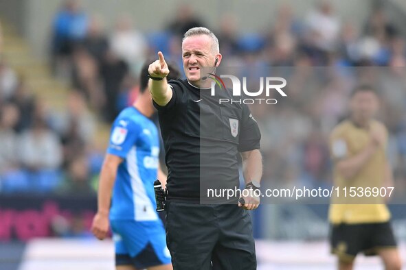 Referee Carl Brook points during the Sky Bet League 1 match between Peterborough and Wrexham at London Road in Peterborough, England, on Aug...