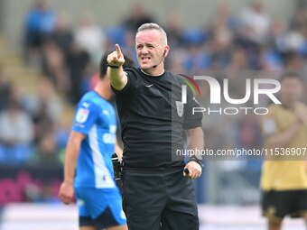 Referee Carl Brook points during the Sky Bet League 1 match between Peterborough and Wrexham at London Road in Peterborough, England, on Aug...