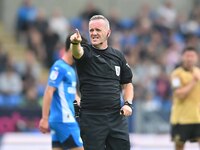 Referee Carl Brook points during the Sky Bet League 1 match between Peterborough and Wrexham at London Road in Peterborough, England, on Aug...