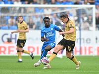 George Dobson (15 Wrexham) is challenged by Kwame Poku (11 Peterborough United) during the Sky Bet League 1 match between Peterborough and W...