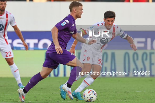 Lucas Beltran of ACF Fiorentina and Matteo Pessina of AC Monza battle for the ball during the Italian Serie A football match between ACF Fio...