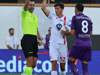 Referee Colombo shows a yellow card to Rolando Mandragora of ACF Fiorentina during the Italian Serie A football match between ACF Fiorentina...