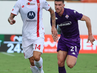 Robin Gosens of ACF Fiorentina and Daniel Maldini of AC Monza battle for the ball during the Italian Serie A football match between ACF Fior...