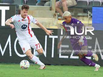 Domilson Cordeiro Dos Santos Dodo of ACF Fiorentina and Georgios Kyriakopoulos of AC Monza battle for the ball during the Italian Serie A fo...